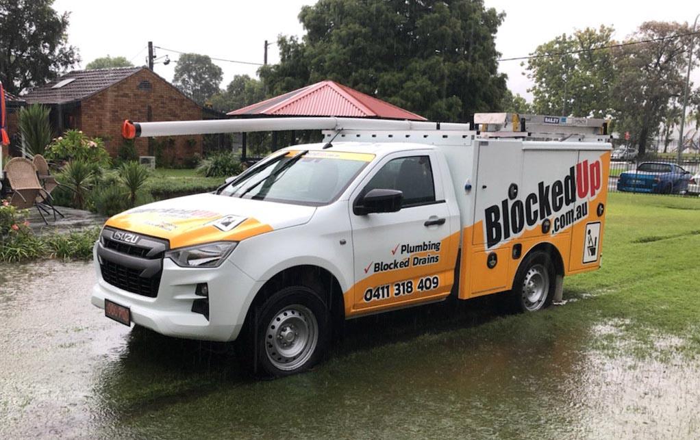 Blocked Up Plumbing ute parked at Central Coast job site